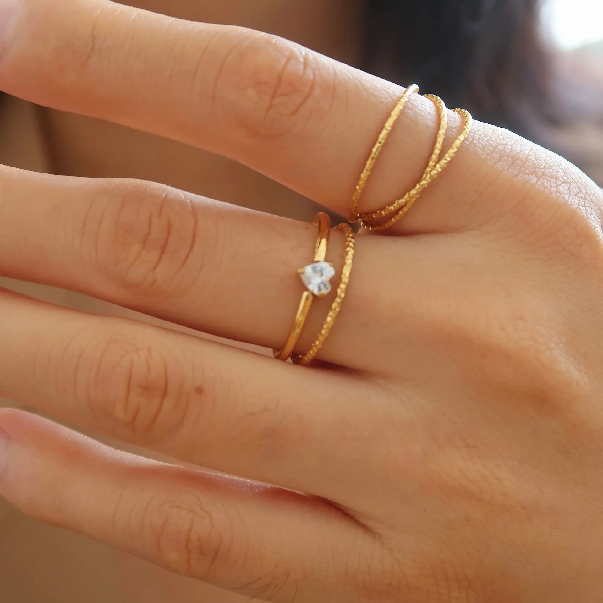 Golden stainless steel love heart ring with an oval ring bath design.