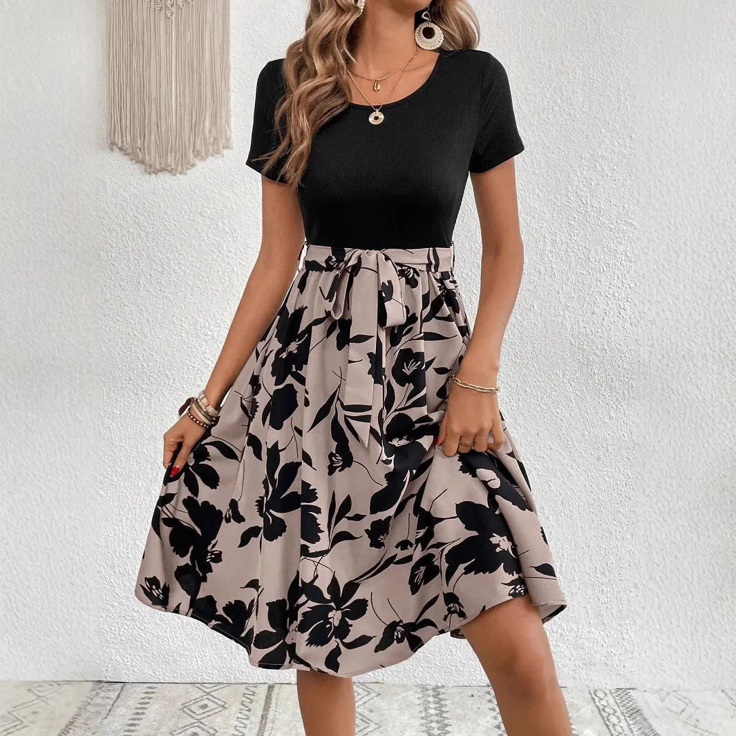Women's khaki floral print A-line dress with lace-up shoulder straps on a hanger.