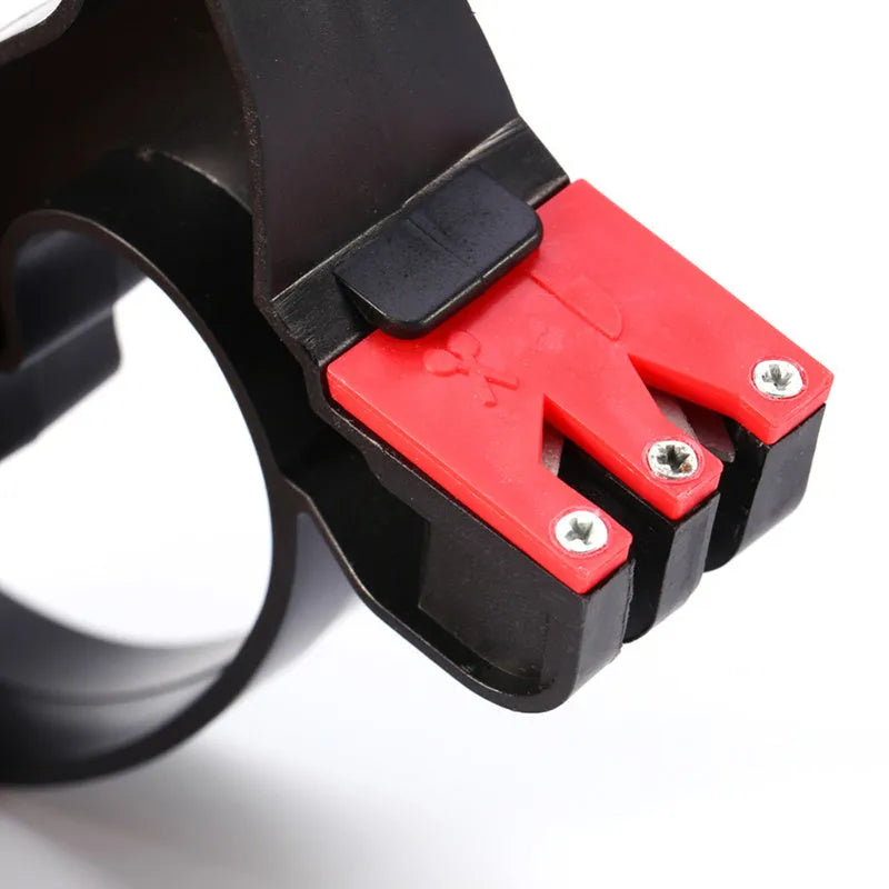 Black handheld knife and scissor sharpener with ergonomic handle on a plain background.