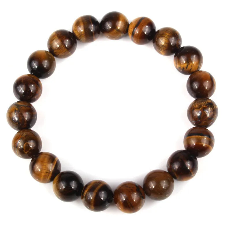 Natural tiger's eye crystal bracelet with round geometric beads in various colours and sizes on a wrist.