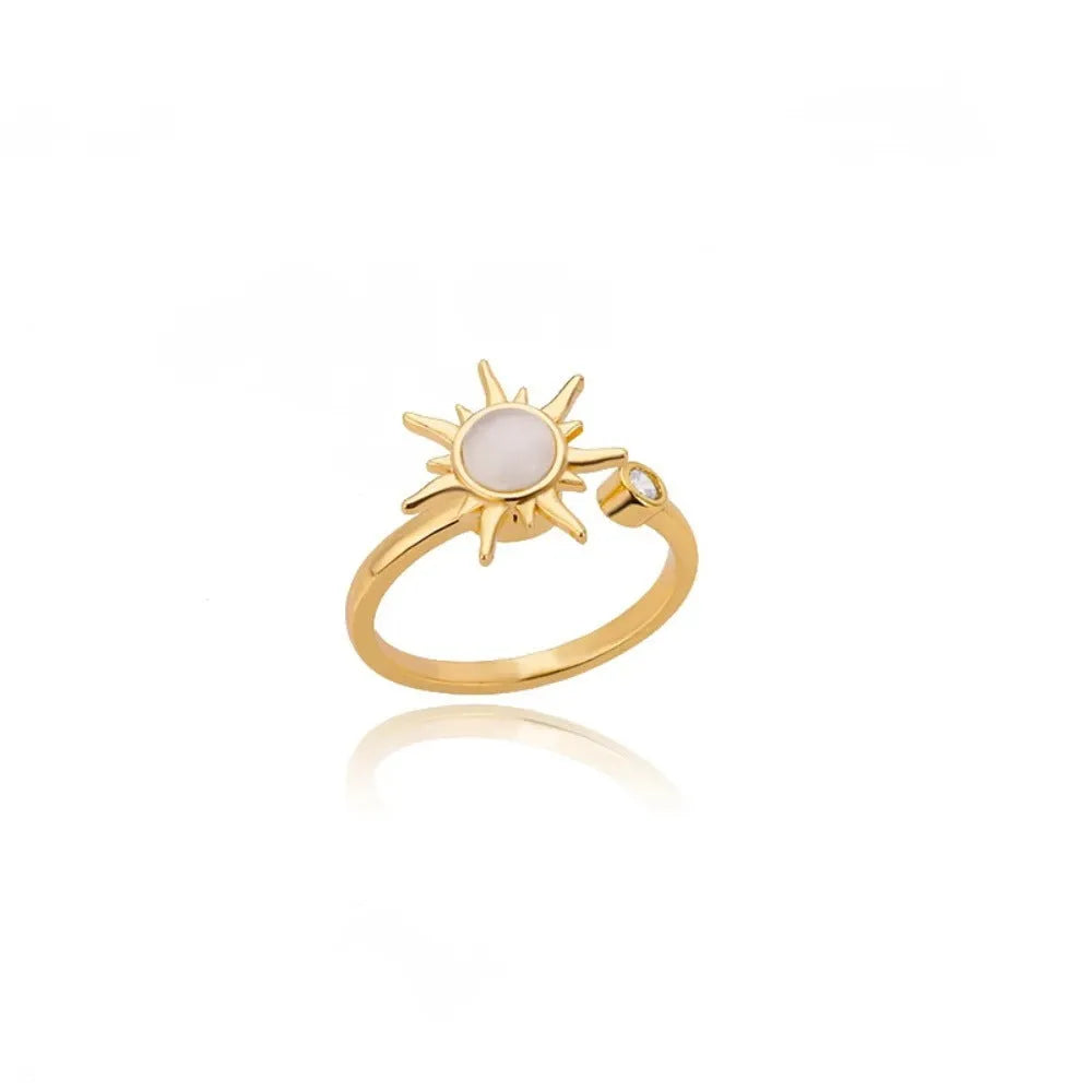 Adjustable rotating decompression ring in gold electroplated copper with geometric design
