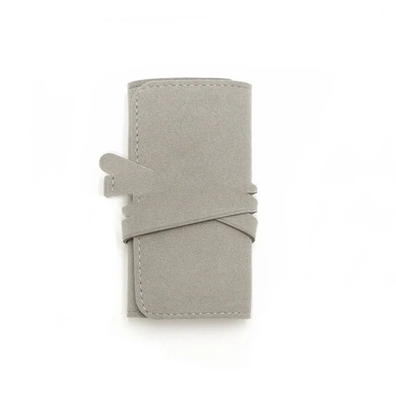 Brown soft microfiber PU leather jewelry storage bag measuring 12x12 cm for earrings and watches.