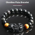 Black Mexico Gold Sheen Obsidian pi xiu bracelet with ethnic styling on wrist