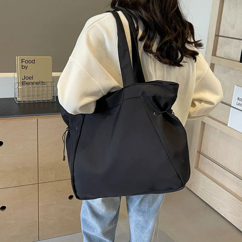 Foldable Oxford cloth commuter tote bag in street trend style, shown in multiple colour options.
