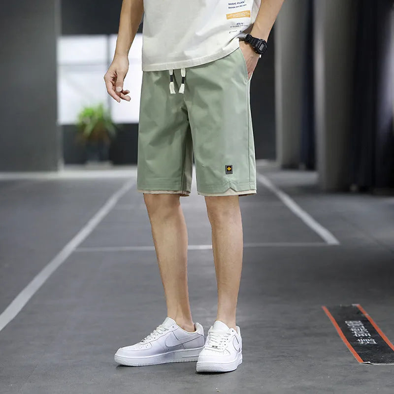 Casual polyester beach shorts with micro elasticity in Korean loose style, available in green, black, khaki and blue colours