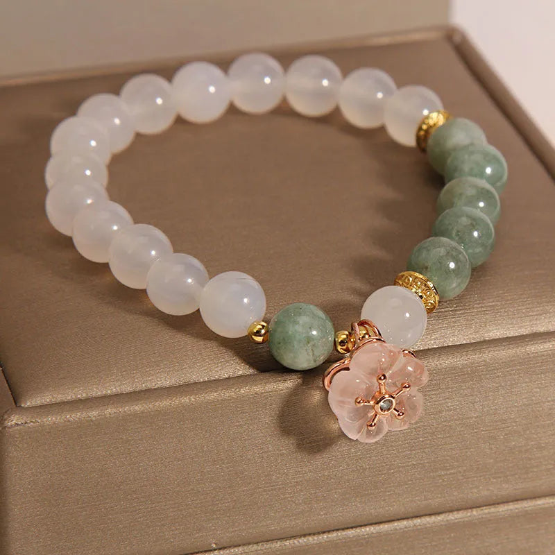 Women's floral bracelet made of white agate and jadeite stones set in jade.