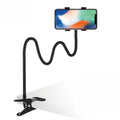 Black metal lazy stand gadget with rotary clip holding a mobile phone on a bedside table