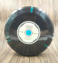 Black or white automatic floor sweeper robot on a hardwood floor.