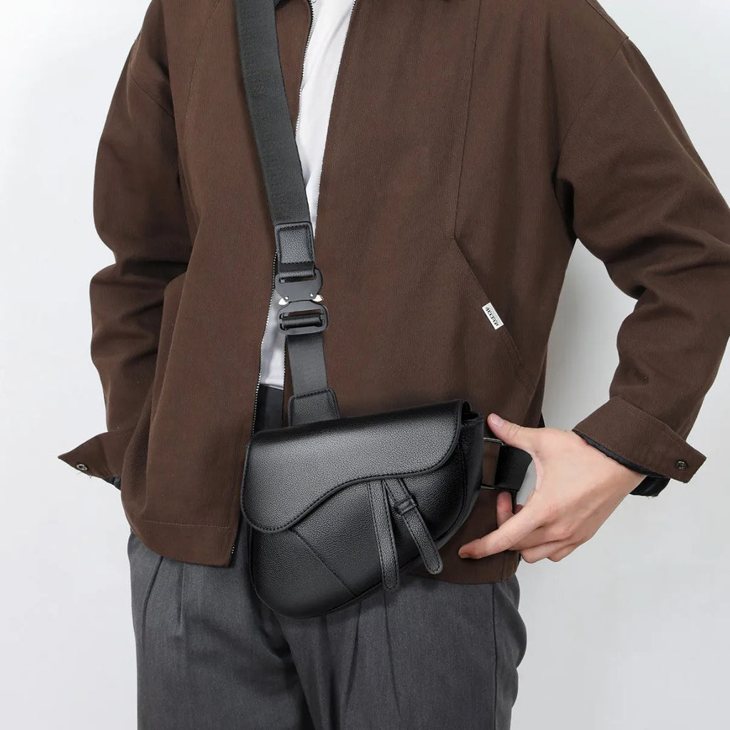 Unisex saddle shoulder crossbody chest bag in black synthetic leather with stitching and splicing details