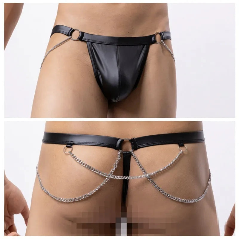 Men's black patent leather thong shorts with a metallic chain detail on the front.