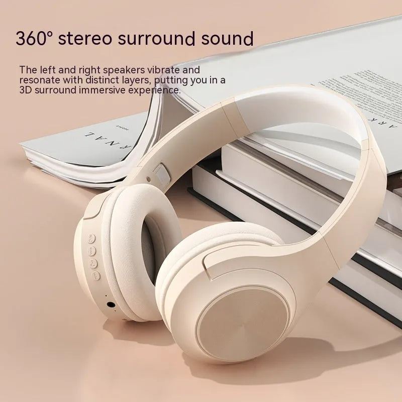 Over-ear wireless Bluetooth headset in Ivory White with a matching charging case on a table.