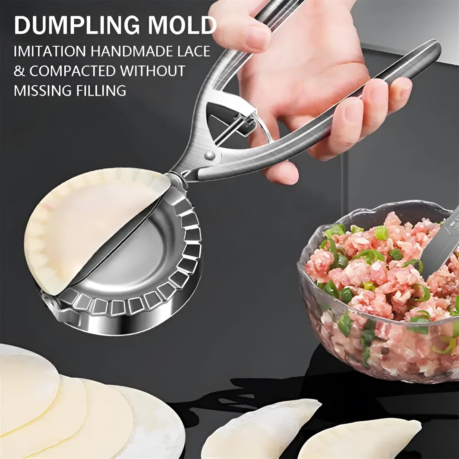 Silver stainless steel manual dumpling maker press tool on a kitchen surface.