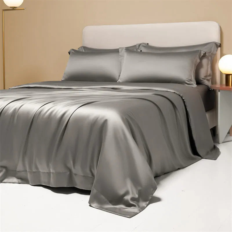 A neatly made bed with a Lenzing Tencel duvet cover and pillowcases in a soft grey colour.