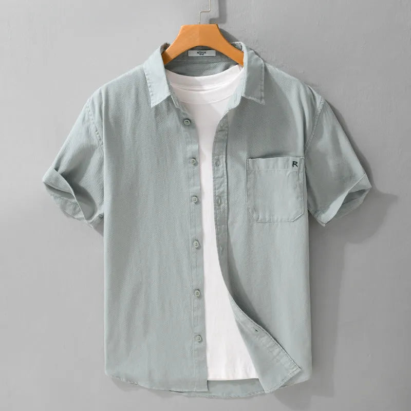 Man wearing a loose light khaki pure cotton short-sleeved cardigan-style shirt.