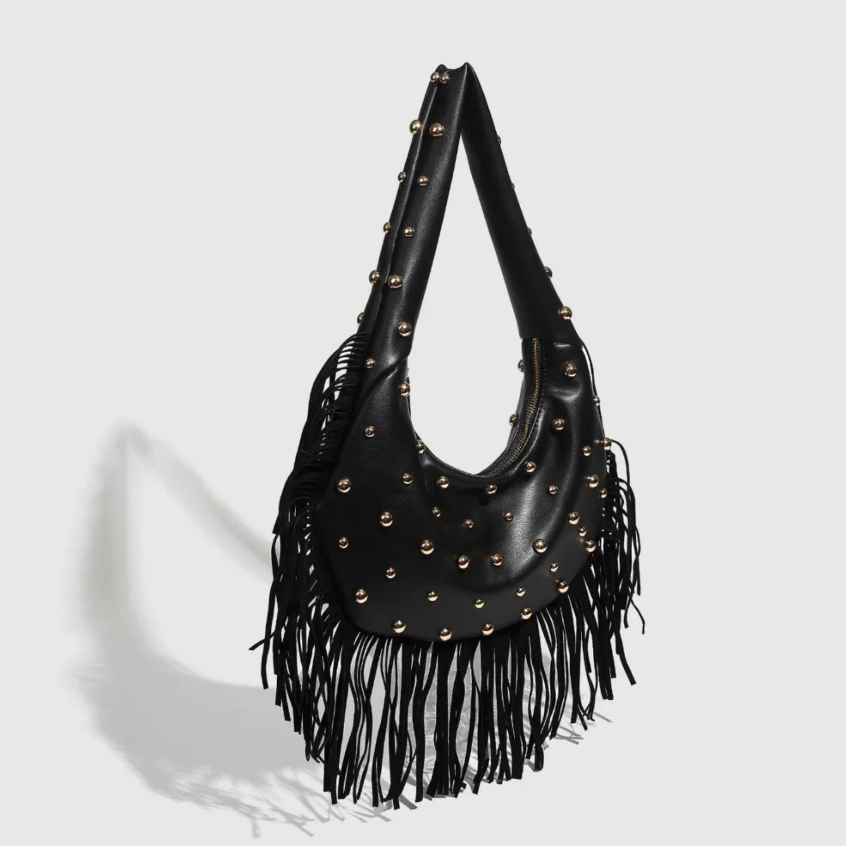 Retro-style black tassel shoulder handbag showing structured shape and decorative tassel.