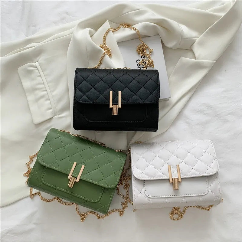 Women's white diamond lattice chain crossbody bag showing adjustable strap and structured shape