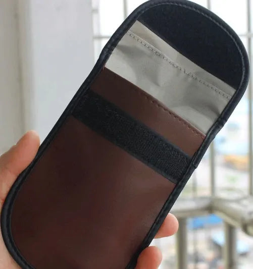 Black RFID signal blocker bag showing 13.5cm by 9.5cm dimensions on a flat surface.