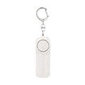 Pink girls personal safety alarm showing compact size next to a key for scale