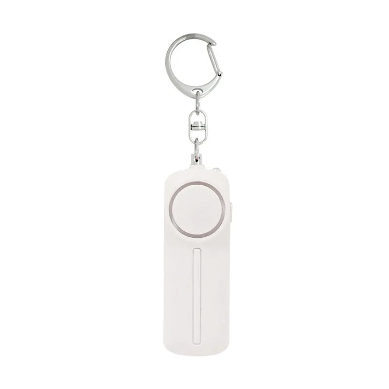 Pink girls personal safety alarm showing compact size next to a key for scale