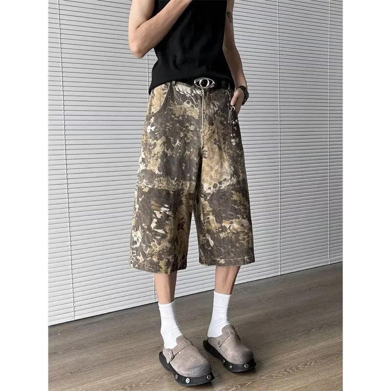 Yellow denim jeans with a snake camouflage pattern and cropped leg hem.