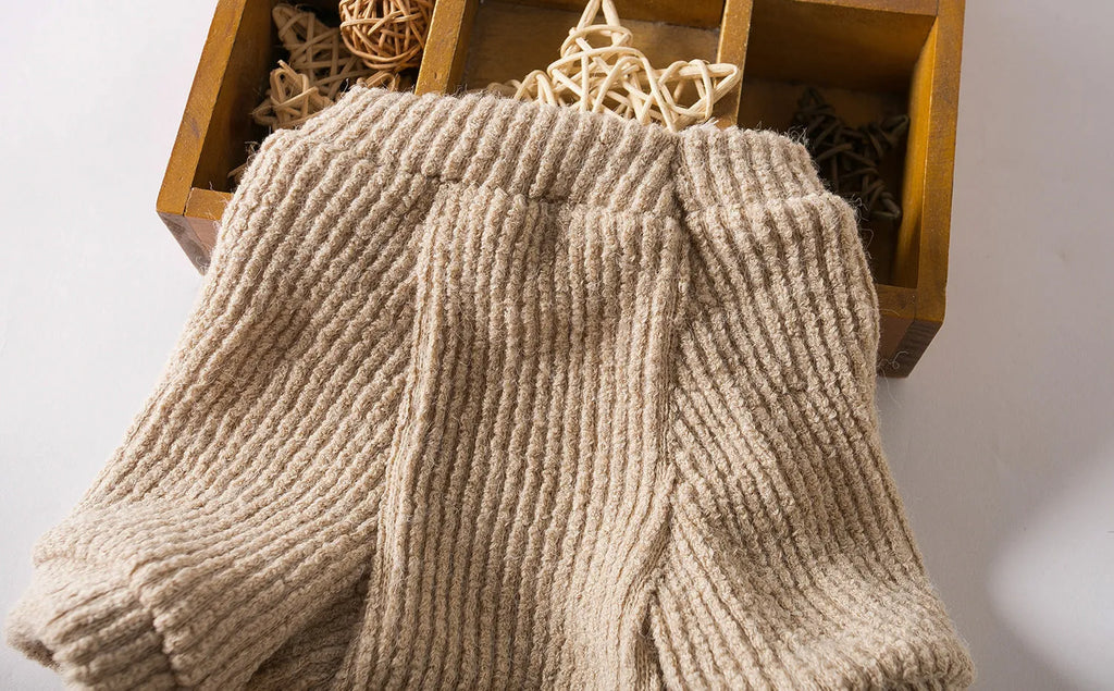 Brown cloth pullover sweater on a small dog, showing casual design.