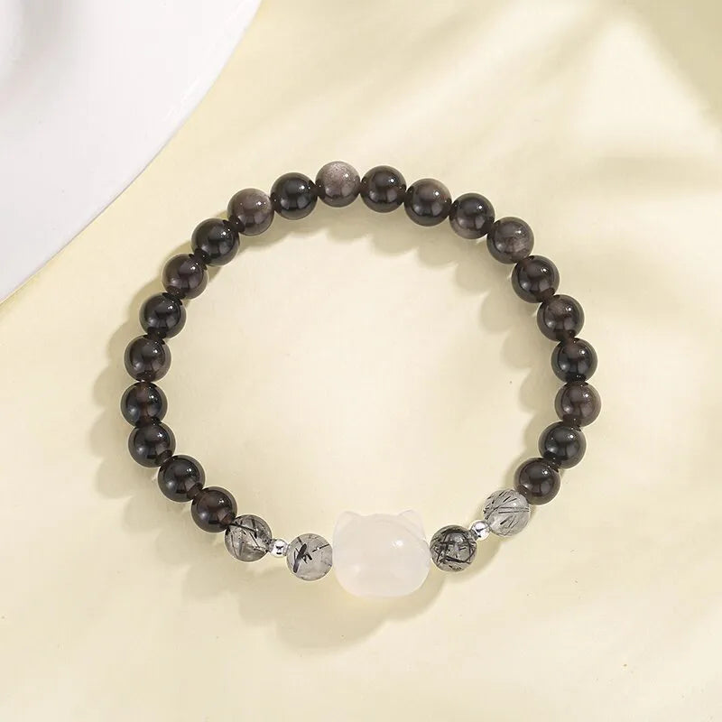 Women's obsidian crystal bracelet with silver cat charm and zodiac animal modelling on adjustable band
