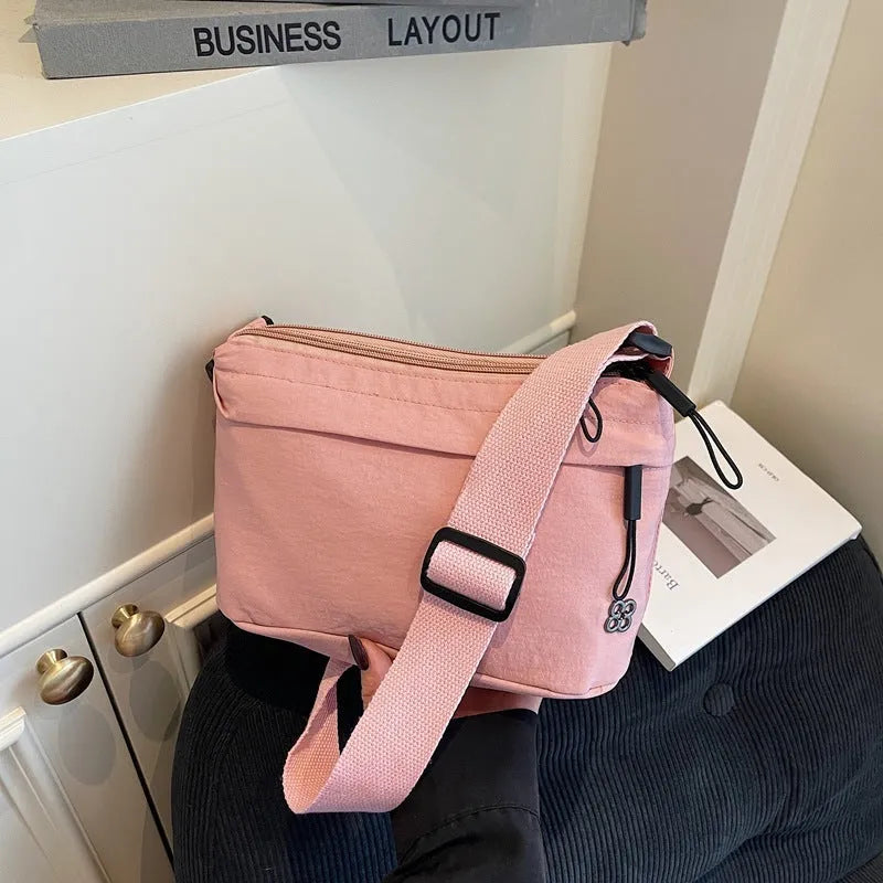 Soft cloth daily lightweight commuter crossbody bag in beige with sandwich pocket and sewn-thread detailing