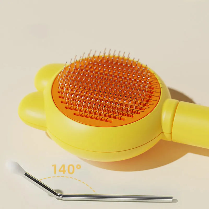 Self-cleaning pet hair brush with release button and rubber-tipped metal pins for cats and dogs.