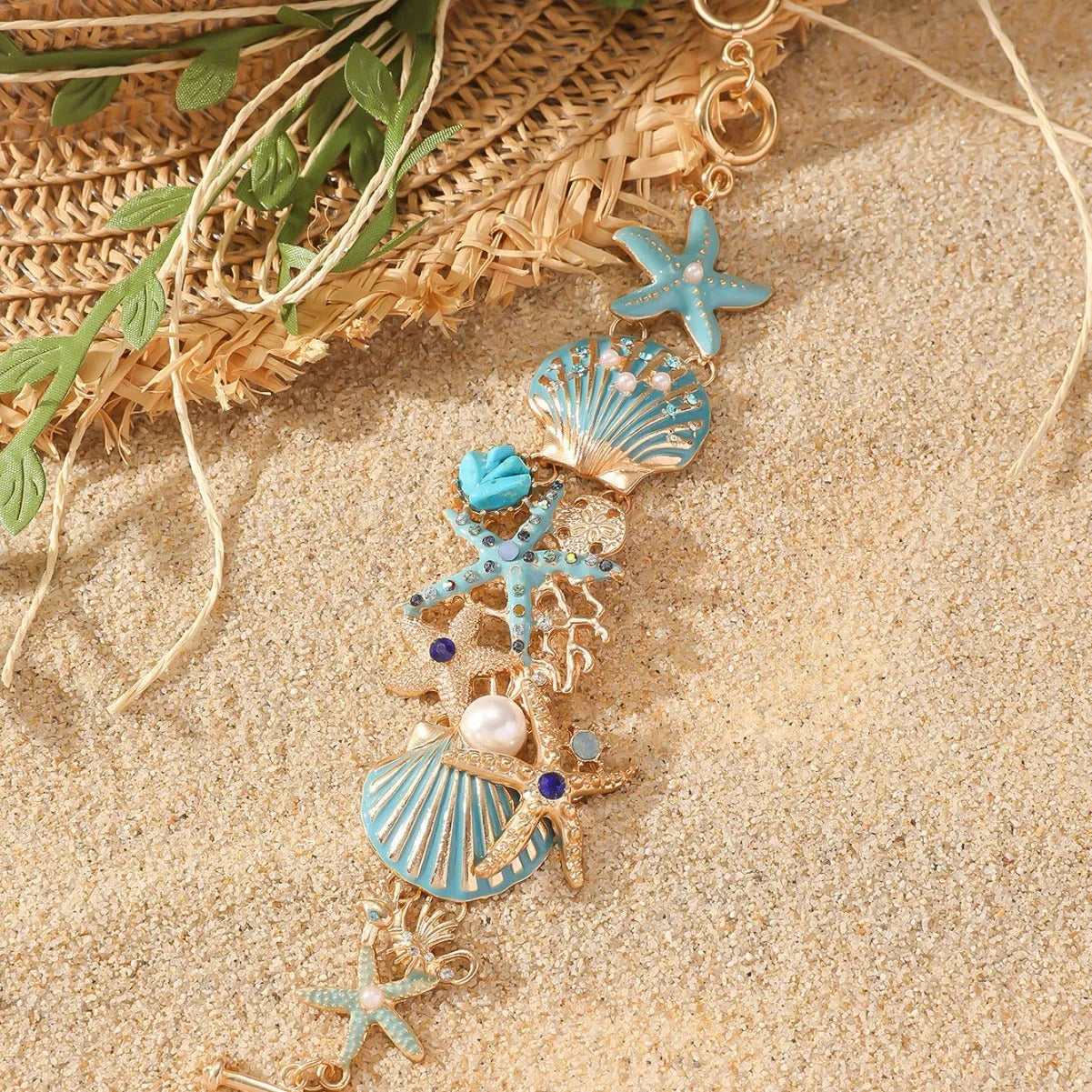 Women's alloy rhinestone nautical bracelet with starfish and anchor charms in turquoise, red, or blue.