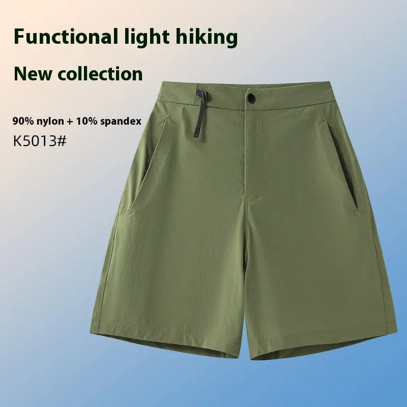 Man wearing khaki athletic shorts with four-way stretch, demonstrating movement for running or climbing.
