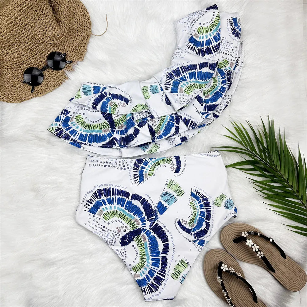 White women's one-shoulder swimsuit bikini with lotus leaf trim and high-leg split.