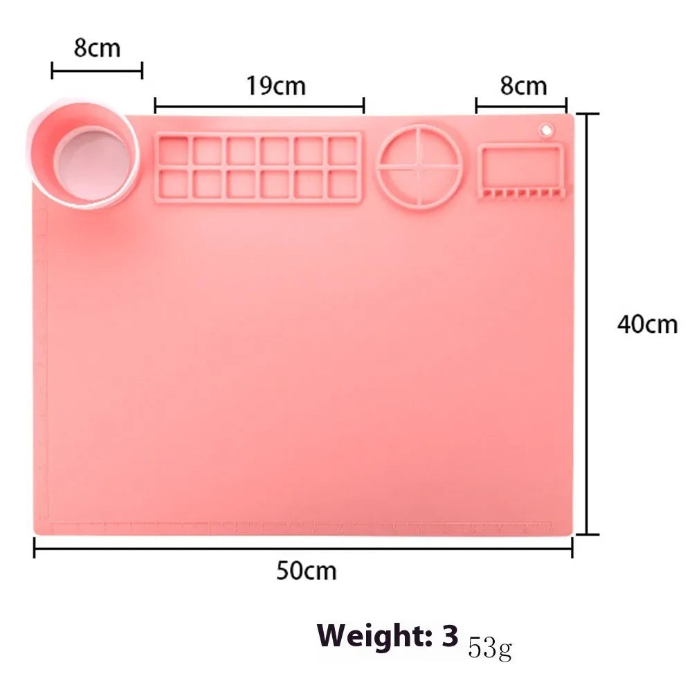 Large light blue silicone painting mat with dimensions 50cm by 40cm laid flat on a table.