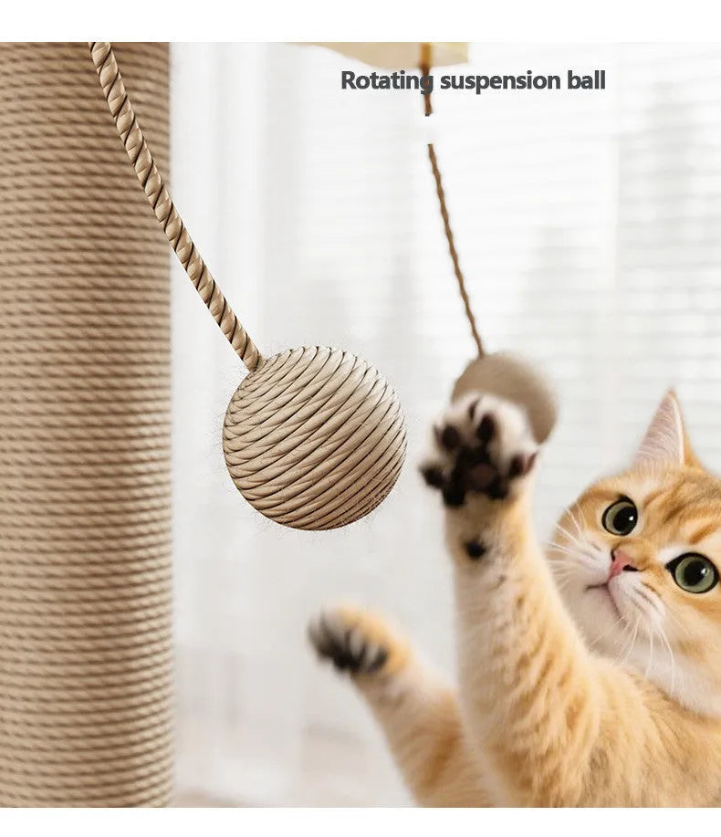 Natural wood tone cat climbing frame with a red hanging ball toy and beige carpet leather scratching surfaces.