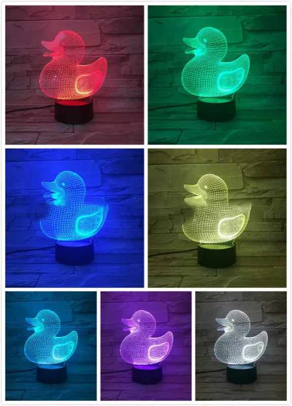 Little yellow duck 3D night light on a table with remote control, displaying a blue colour.