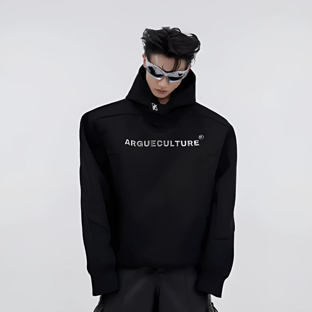 Man wearing a loose red hooded sweater with metallic 3D printing and structured shoulder pads.