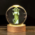 White crystal ball desk ornament on a wooden warm light base, showing purity-themed designs.