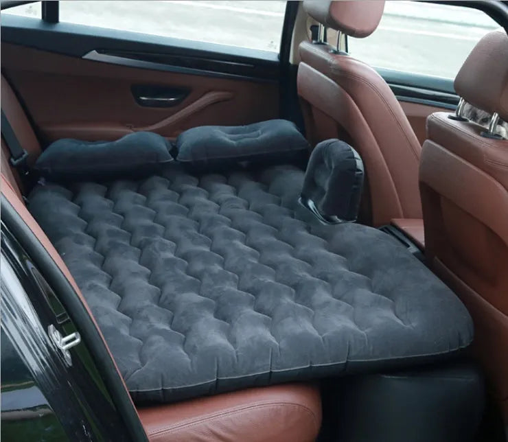 Black thickened flocking inflatable car bed set up in a vehicle with pillows.