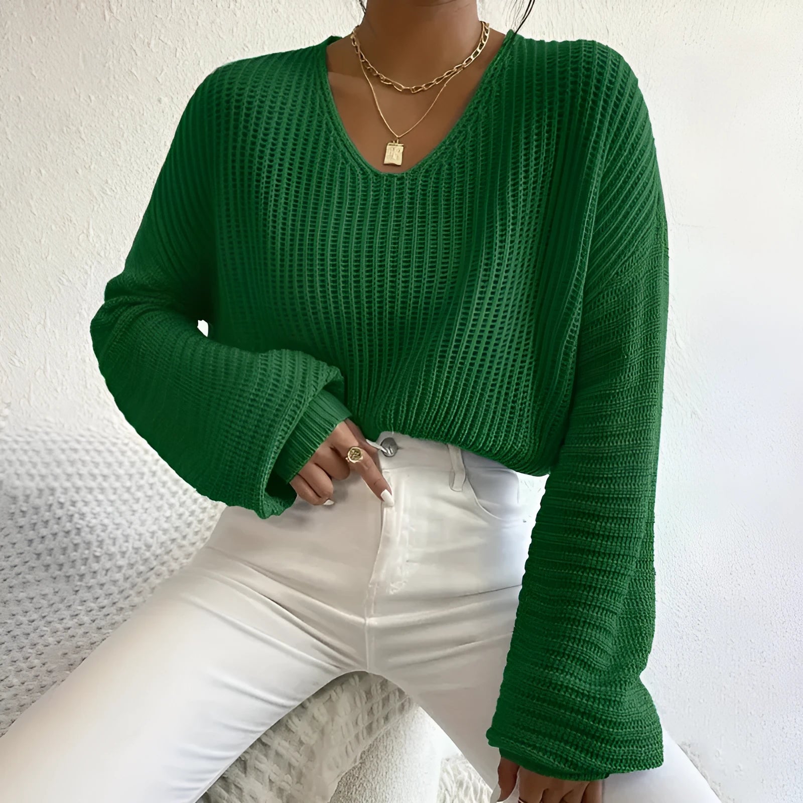 A woman's solid colour long sleeve pullover jumper in a loose, casual fit.