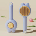 Self-cleaning pet hair brush with release button and rubber-tipped metal pins for cats and dogs.