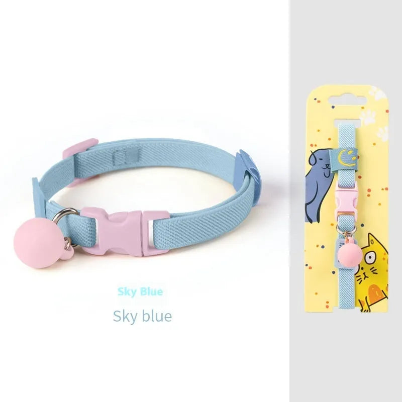 A small, elastic monochrome dog collar in sky blue with a plastic buckle, laid flat.