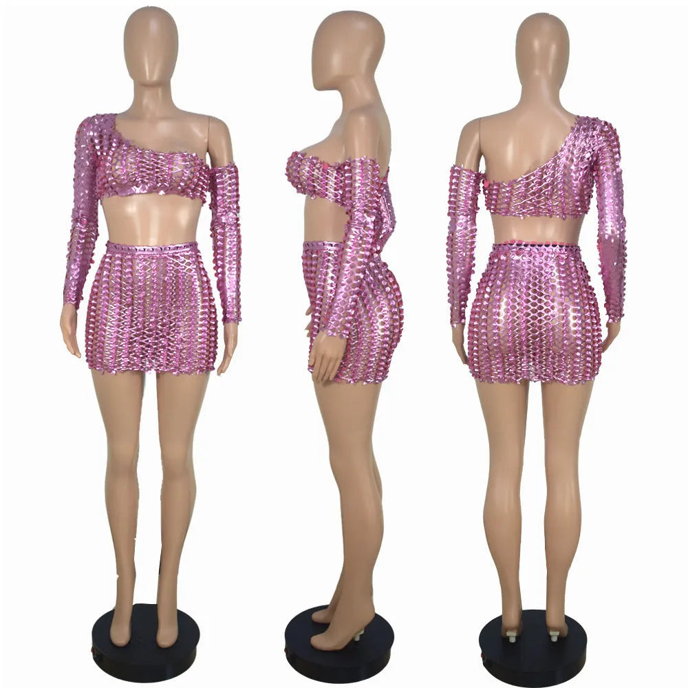 Women's black hollow-out two-piece dress set with sleeveless top and short skirt on a hanger