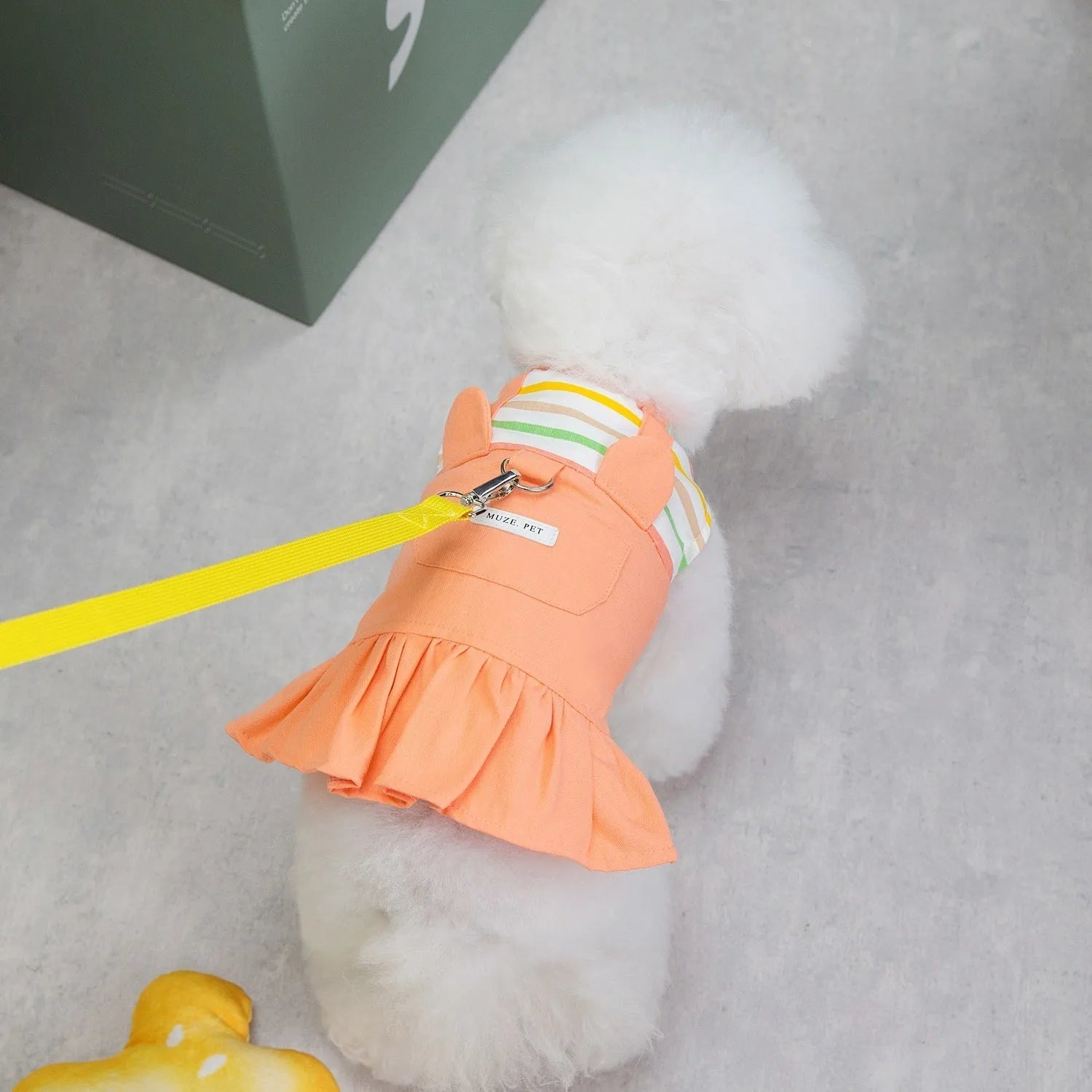 Orange red and yellow striped patchwork cotton skirt for dogs, shown in casual style.
