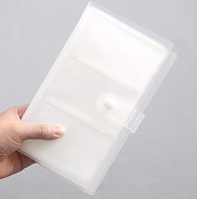 Blue PVC business card holder book with a protective shell and smile logo, shown next to business cards.
