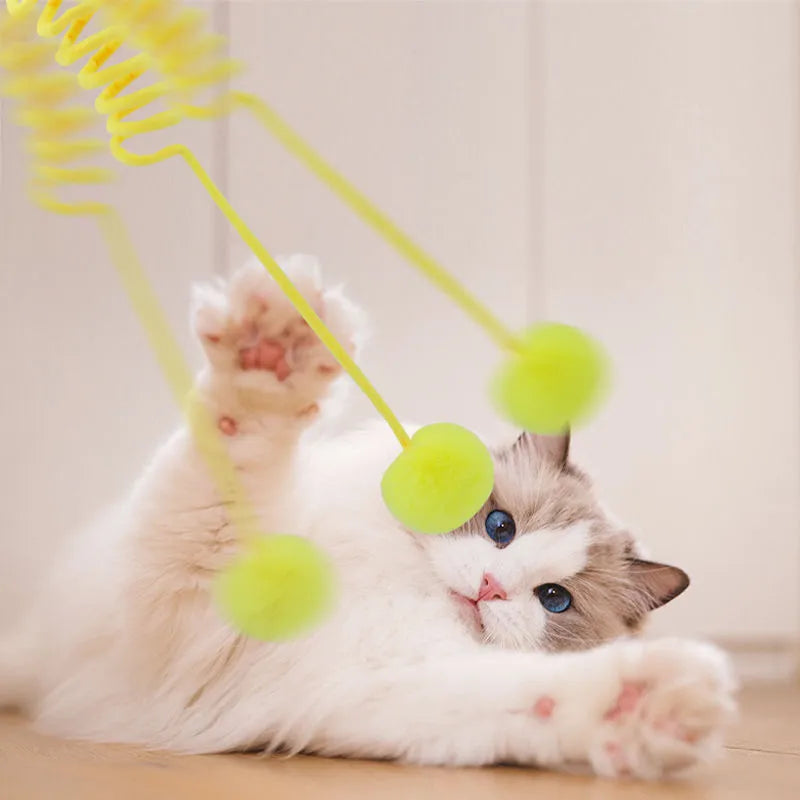 Cat toy with suction cup, spring, rabbit fur ball, and retractable elastic rope on a door