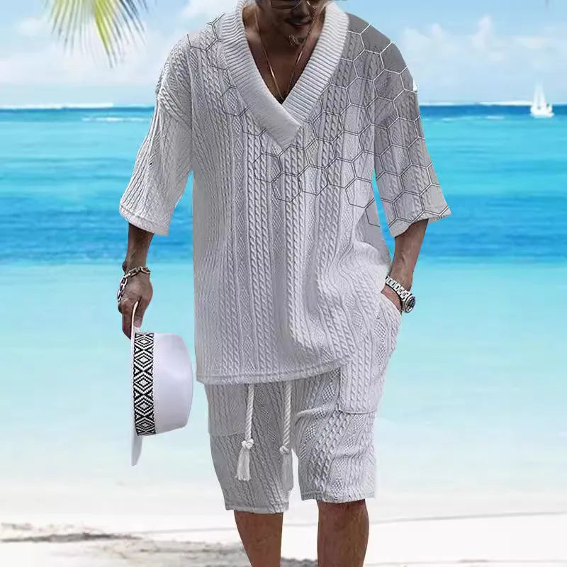 Man modelling a printed drop-shoulder knitted short-sleeved top with matching shorts in a casual setting.