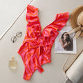 Women's deep V-neck one-piece swimsuit with ruffled shoulders and mesh stitching detail in a printing pattern.
