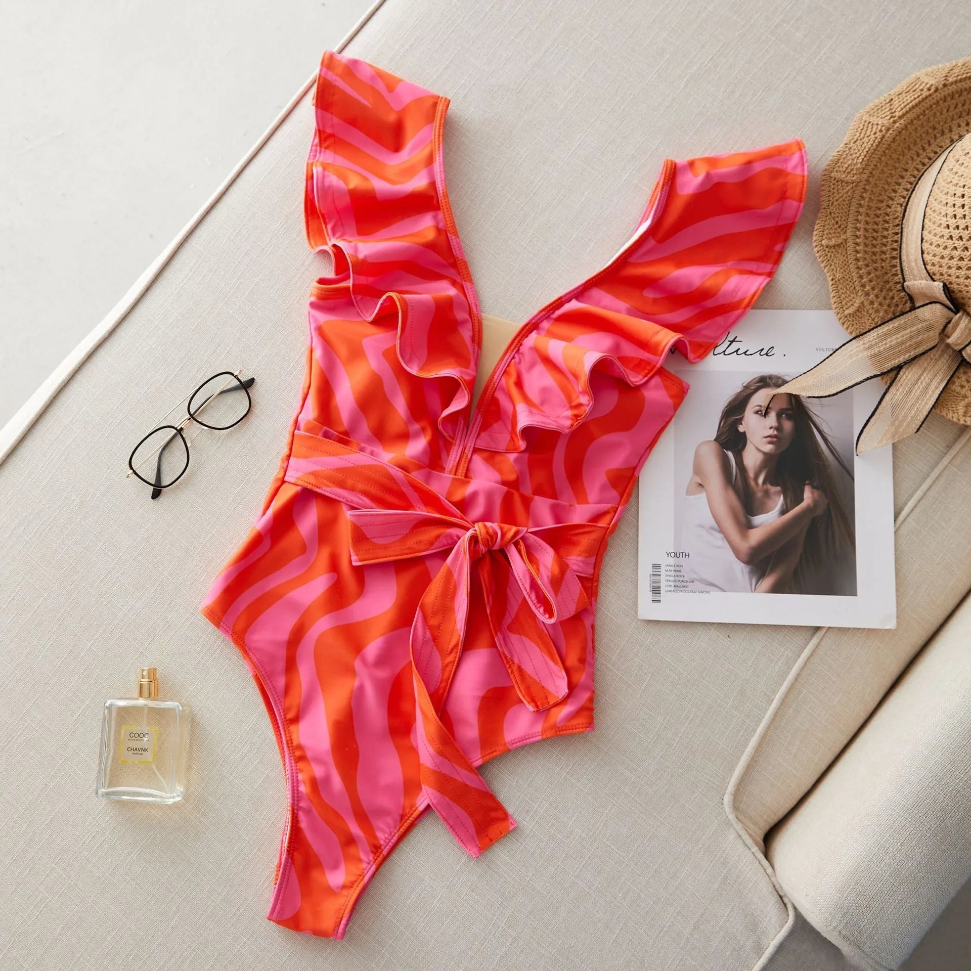 Women's deep V-neck one-piece swimsuit with ruffled shoulders and mesh stitching detail in a printing pattern.