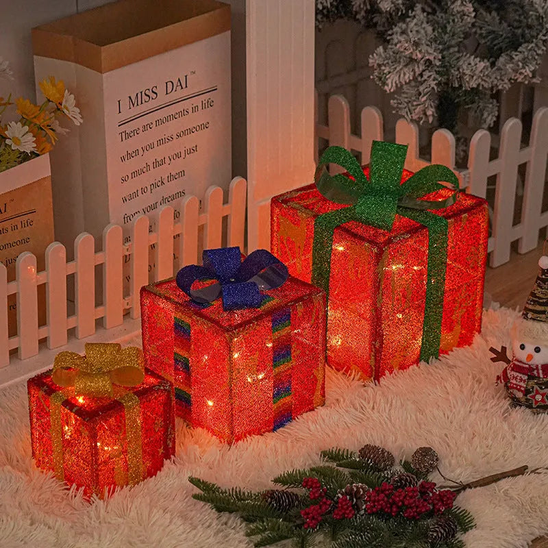 Set of three pre-lit Christmas gift box decorations with bows and LED lights for outdoor use