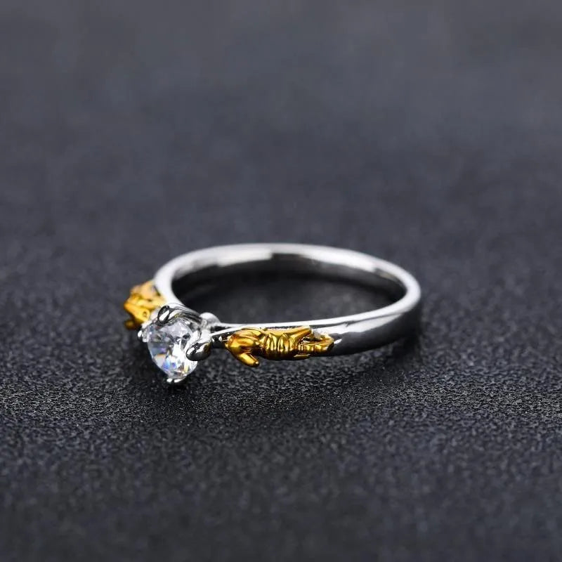 A black gold finished crown motif ring on a copper base, shown on a finger, with detailed modelling visible.