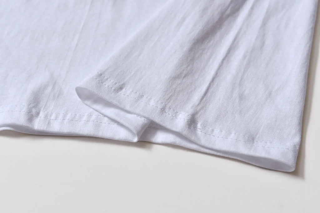 White cotton t-shirt overalls with round neck and short sleeves in loose fit